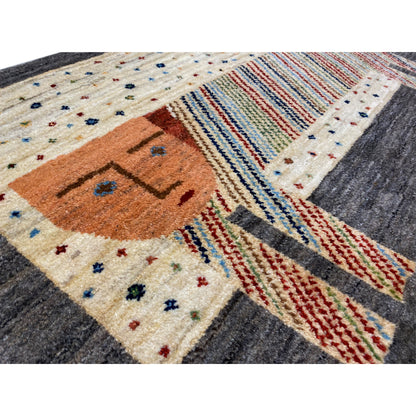 Gabbeh rug close-up: orange elephant face, colorful stripes