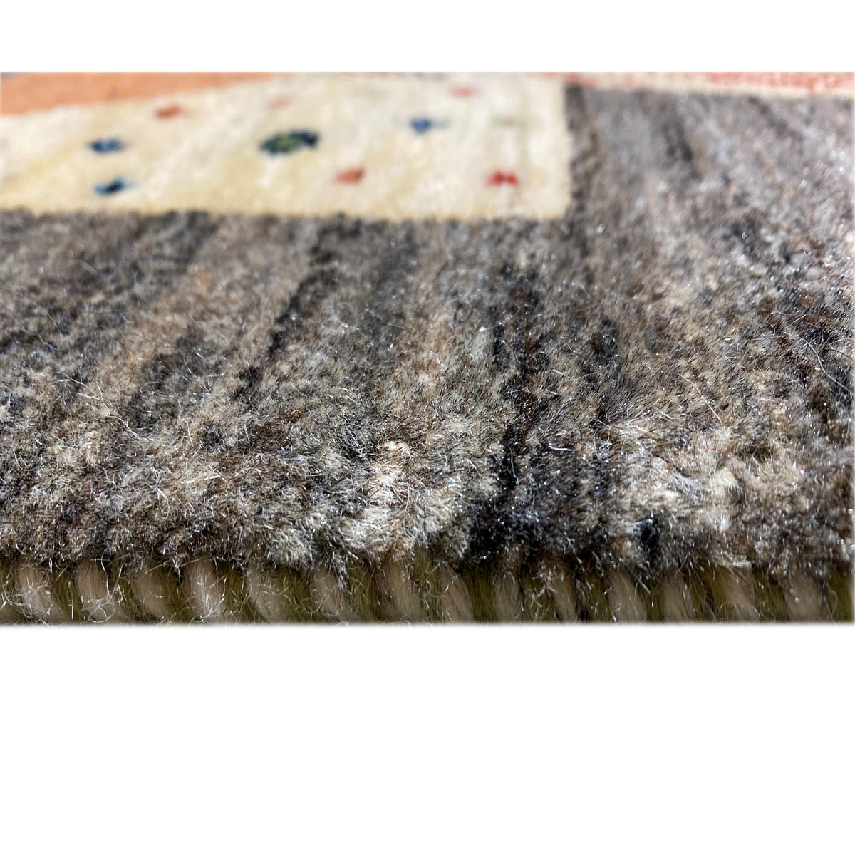 Gabbeh rug weave detail with dense pile and a light-colored edge