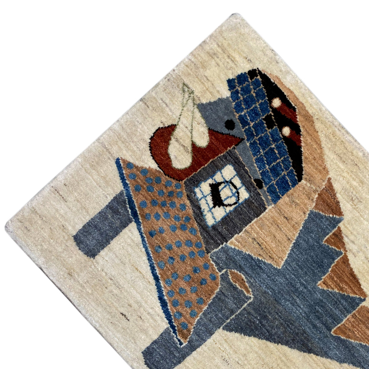 Gabbeh rug detail, beige with a blue pattern, brown triangles, and a red accent