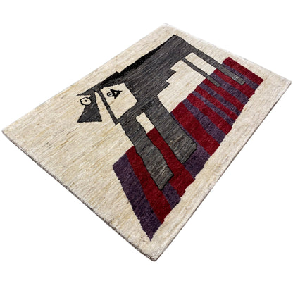 Beige Gabbeh rug with a geometric pattern in black, red, and gray