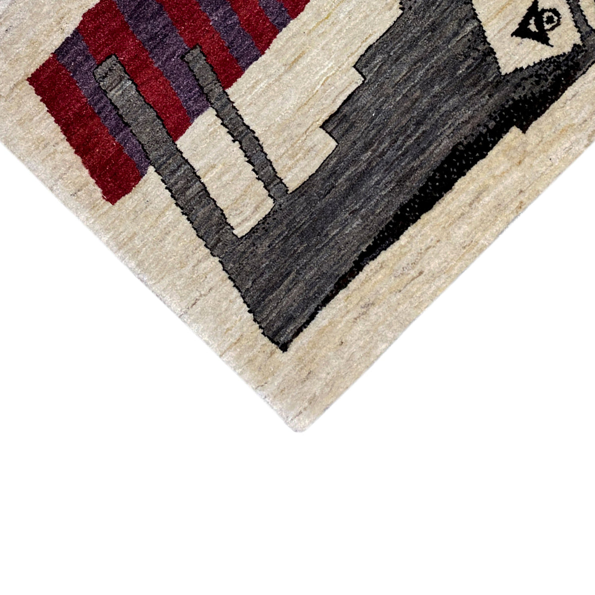 Beige Gabbeh rug, close-up of the patterned edges in black, red, and gray