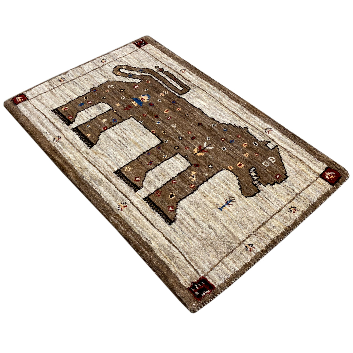 Gabbeh rug corner view with lion motif and dot ornaments, cream and brown