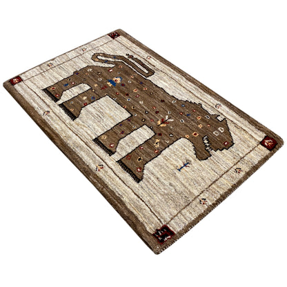 Gabbeh rug corner view with lion motif and dot ornaments, cream and brown