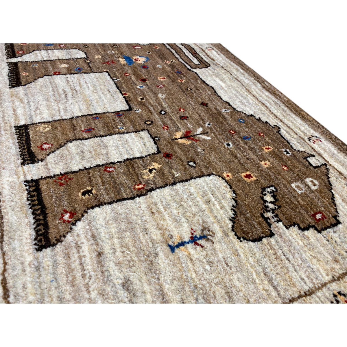 Close-up of a Gabbeh rug with a brown field, beige stripes, and colorful dot motifs