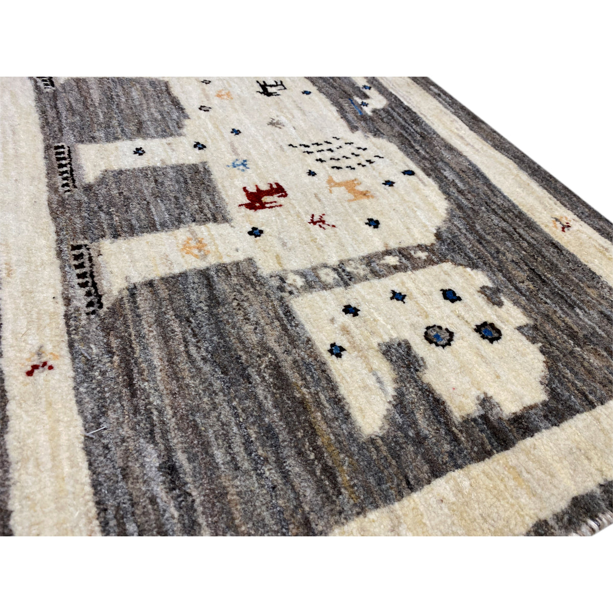 Gabbeh rug 89x60 cm detail view: cream areas, dark gray stripes, colorful symbols
