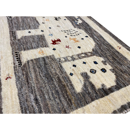Gabbeh rug 89x60 cm detail view: cream areas, dark gray stripes, colorful symbols