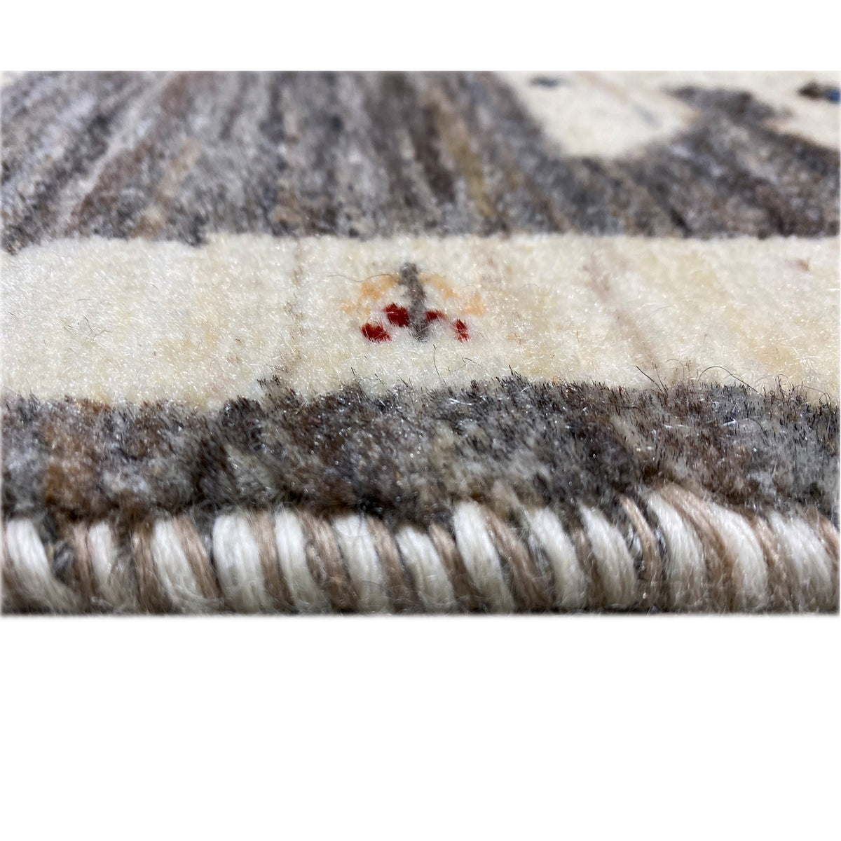 Gabbeh rug 89x60 cm close-up of edge fringe, dark gray and cream with small embroideries
