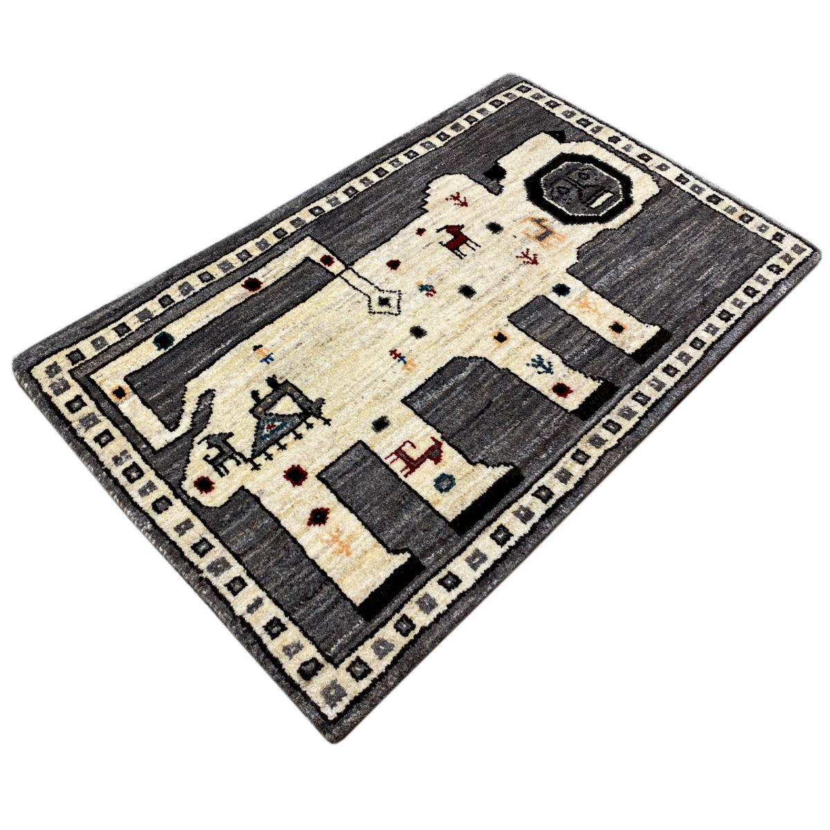 Corner view: gray Gabbeh rug with an ecru central area and dark appliqués