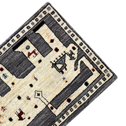 Oblique view of the Gabbeh rug: ecru-colored center with dark border elements