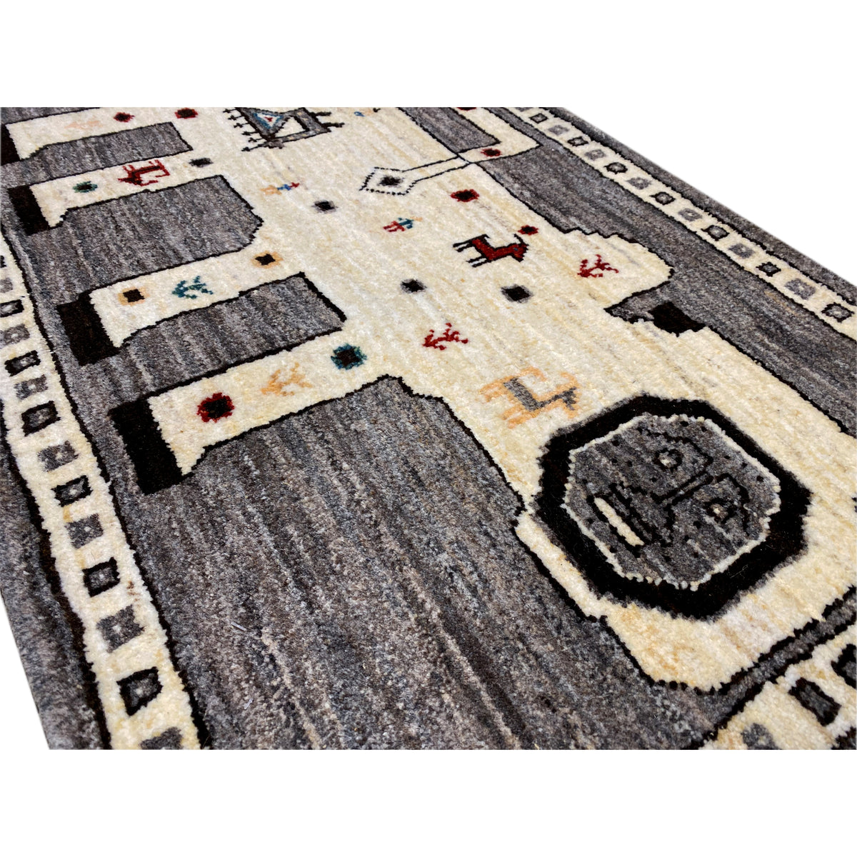 Close-up: Gabbeh rug with a cream-colored field, gray blocks, and decorative embroidered patterns