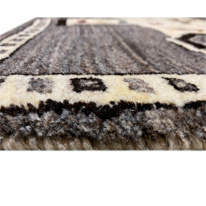 Carpet pile in detail: gray and cream-colored yarn with a dense, short structure