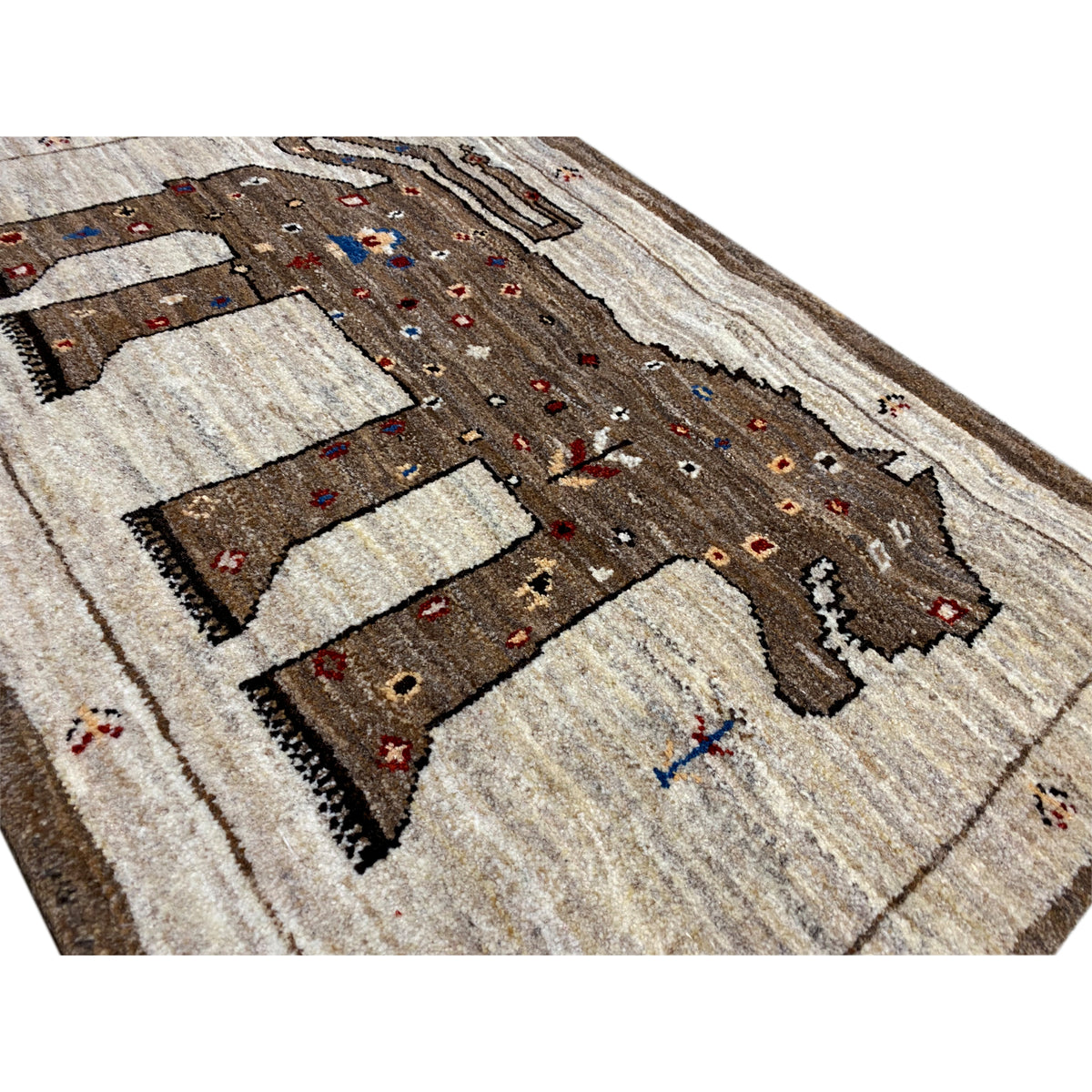 Close-up: Brown Gabbeh rug with a lion motif and colorful ornaments