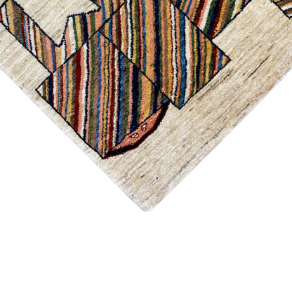 Beige carpet detail with colorful stripes and animal motif, angled