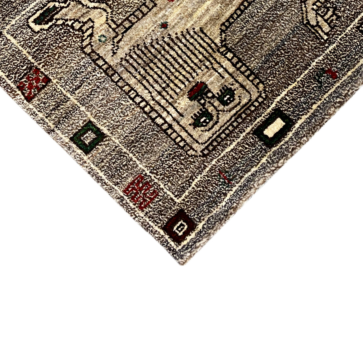 Corner of a gray Gabbeh rug with a central motif and contrasting border squares