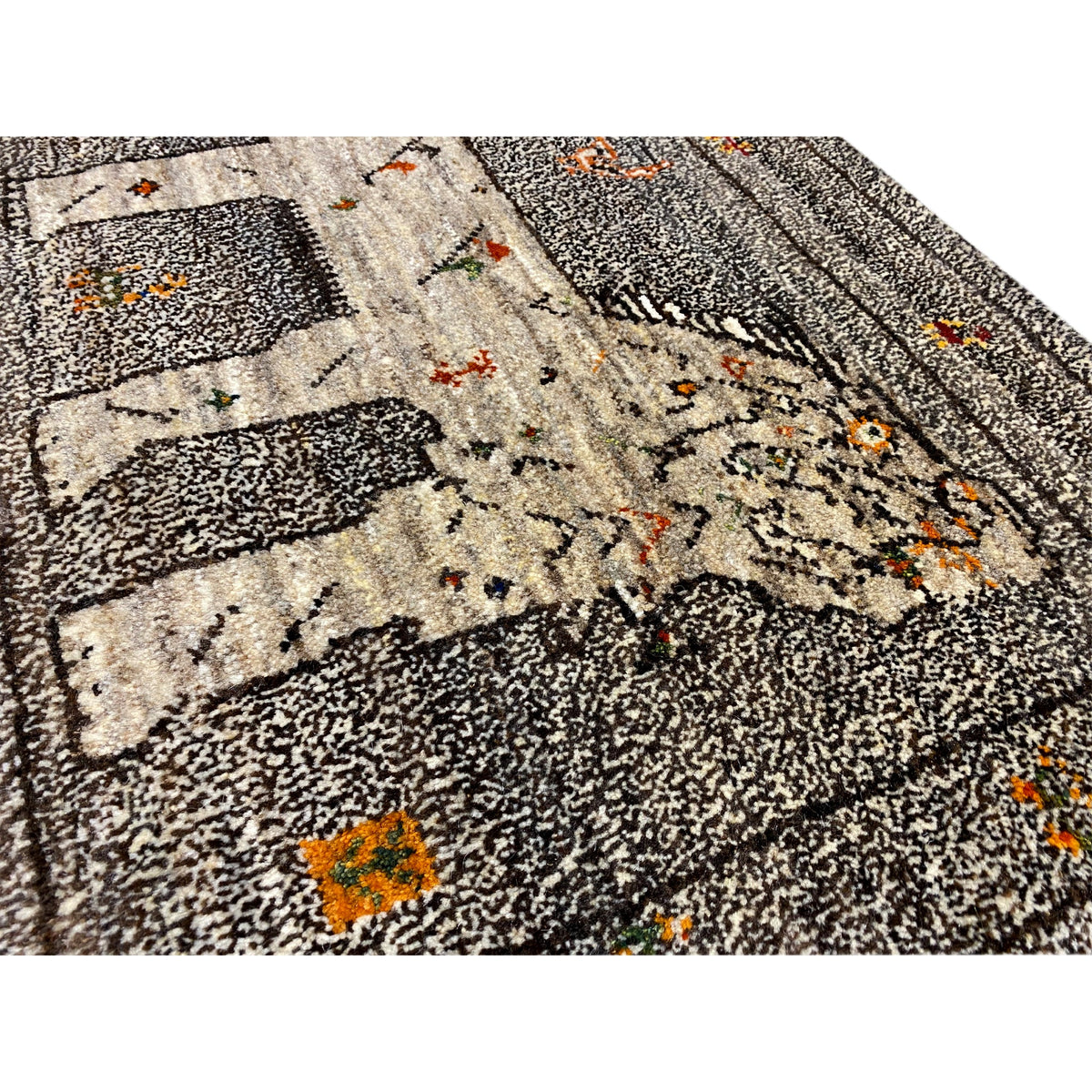 Rug detail: beige design with colorful dots on dark gray pile