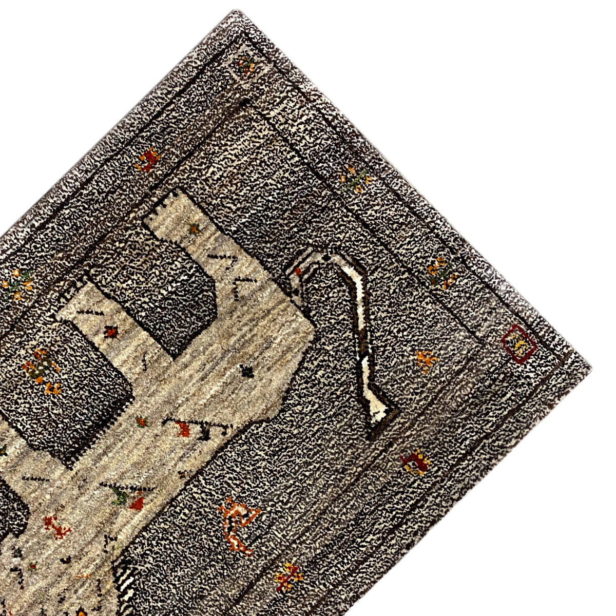 Close-up detail of the Gabbeh rug with decorative ornaments and colorful dots, gray-beige