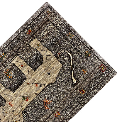 Close-up detail of the Gabbeh rug with decorative ornaments and colorful dots, gray-beige