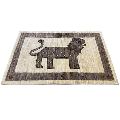 Rectangular Gabbeh rug: beige background with a dark gray lion motif in the central area.