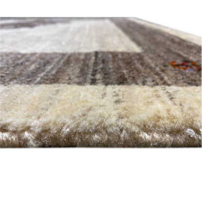 Close-up view of the carpet edge: short beige pile with dark accents and stripes.