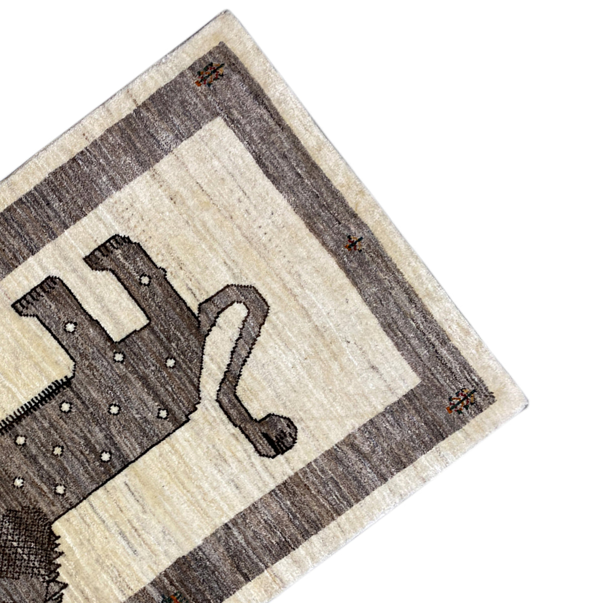 Gabbeh rug corner with lion motif: beige patterned field and gray-brown border stripes.