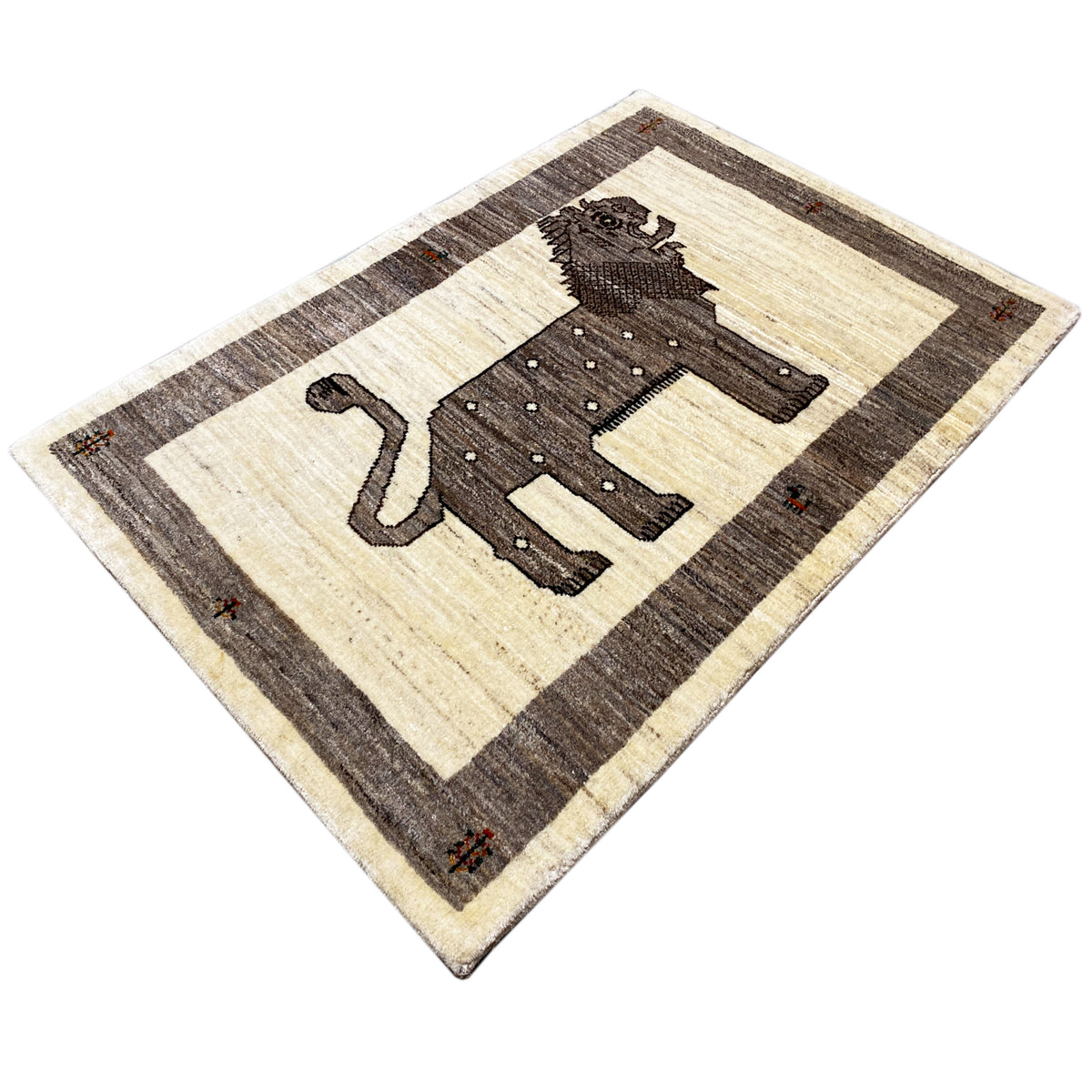 Gabbeh rug with a lion motif, beige field and dark border, rectangular.