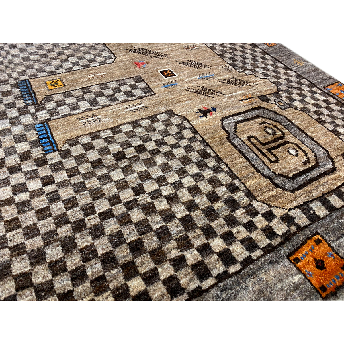 Close-up of the beige Gabbeh rug: checks, figures, and a lion medallion in the pattern