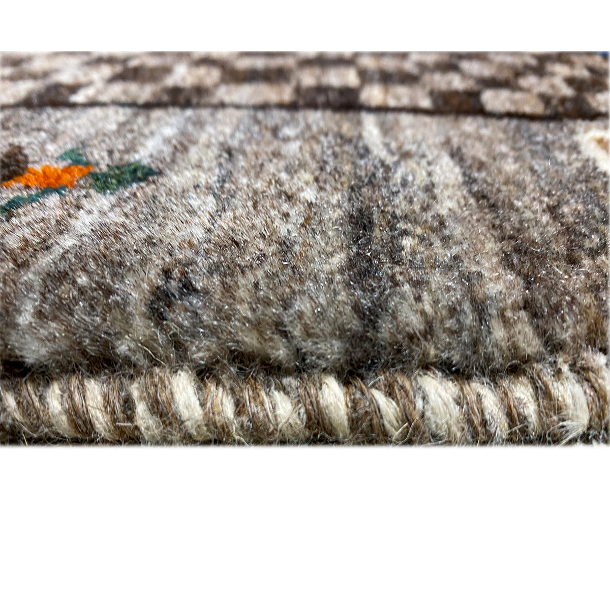 Texture view of the beige Gabbeh rug with pile and bound rug edge