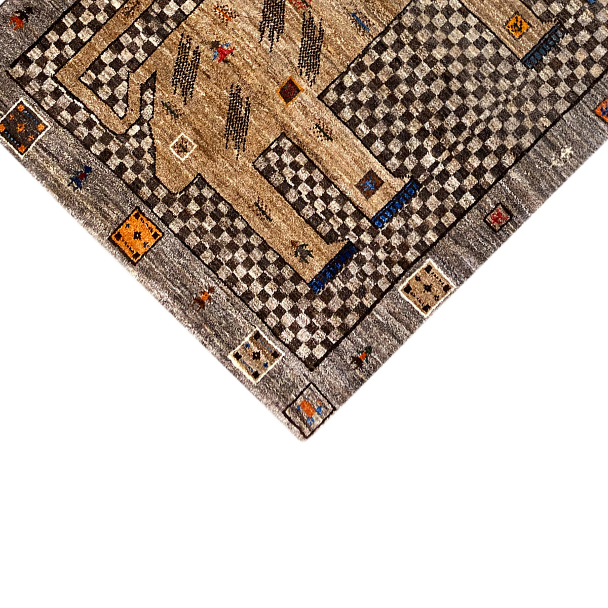 Detail of the beige Gabbeh rug with figures, diamonds, and lion motif near the corner