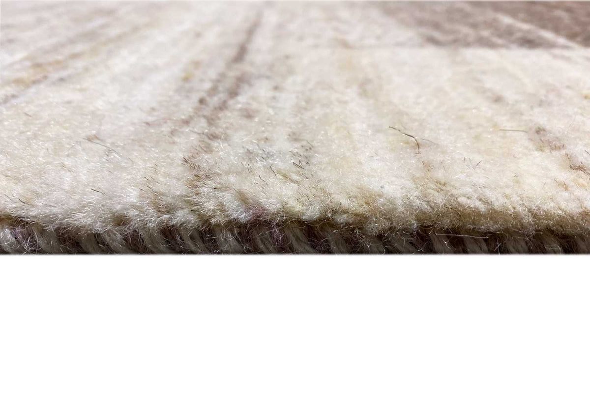 Detailed view: soft cream-colored carpet surface with a short pile along the edge