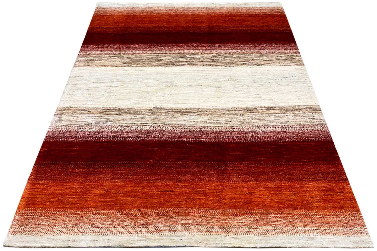 Rug in triangular view with horizontal stripes in red, terracotta, and cream