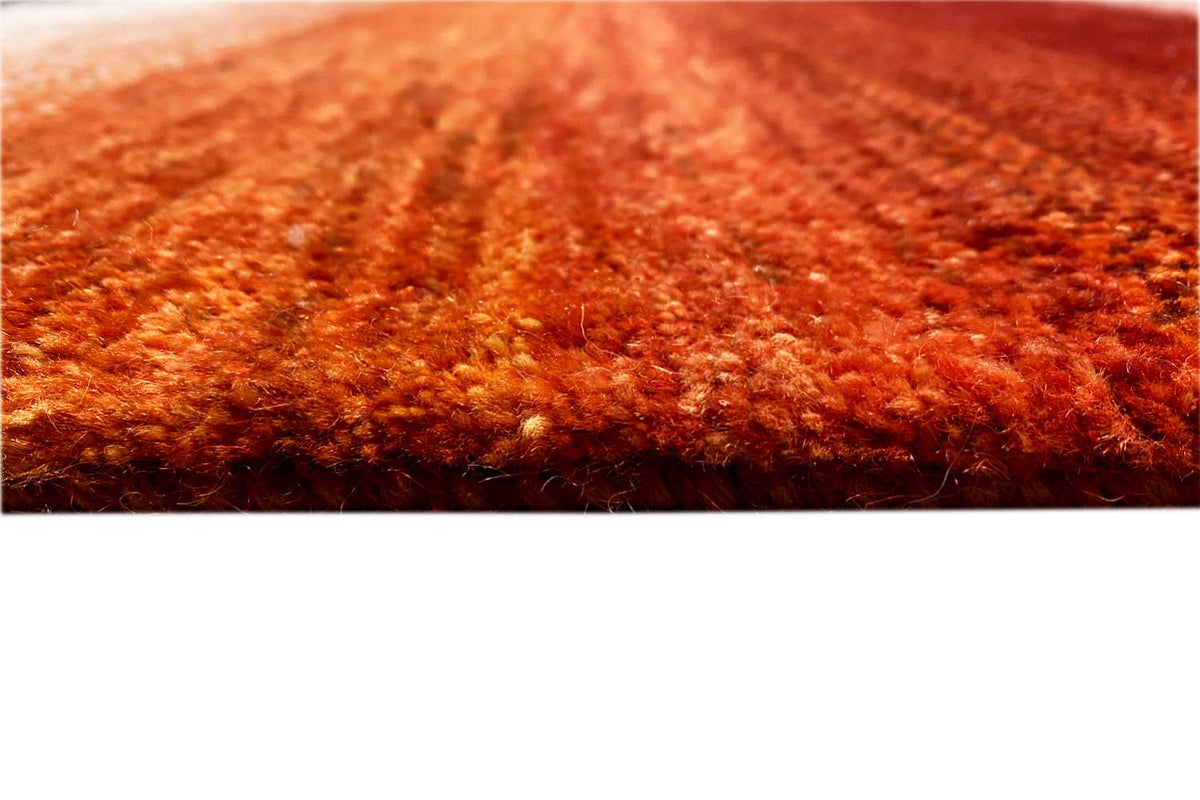 Rug pile in a rich rust red, with a fine mottled texture