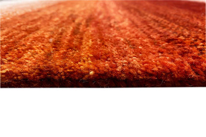 Rug pile in a rich rust red, with a fine mottled texture