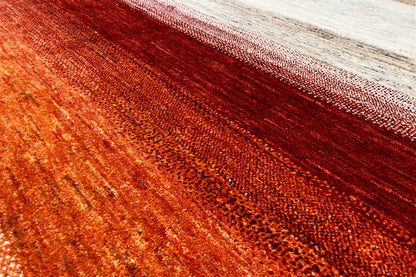 Rug detail with mottled rust red and a narrow cream-colored border