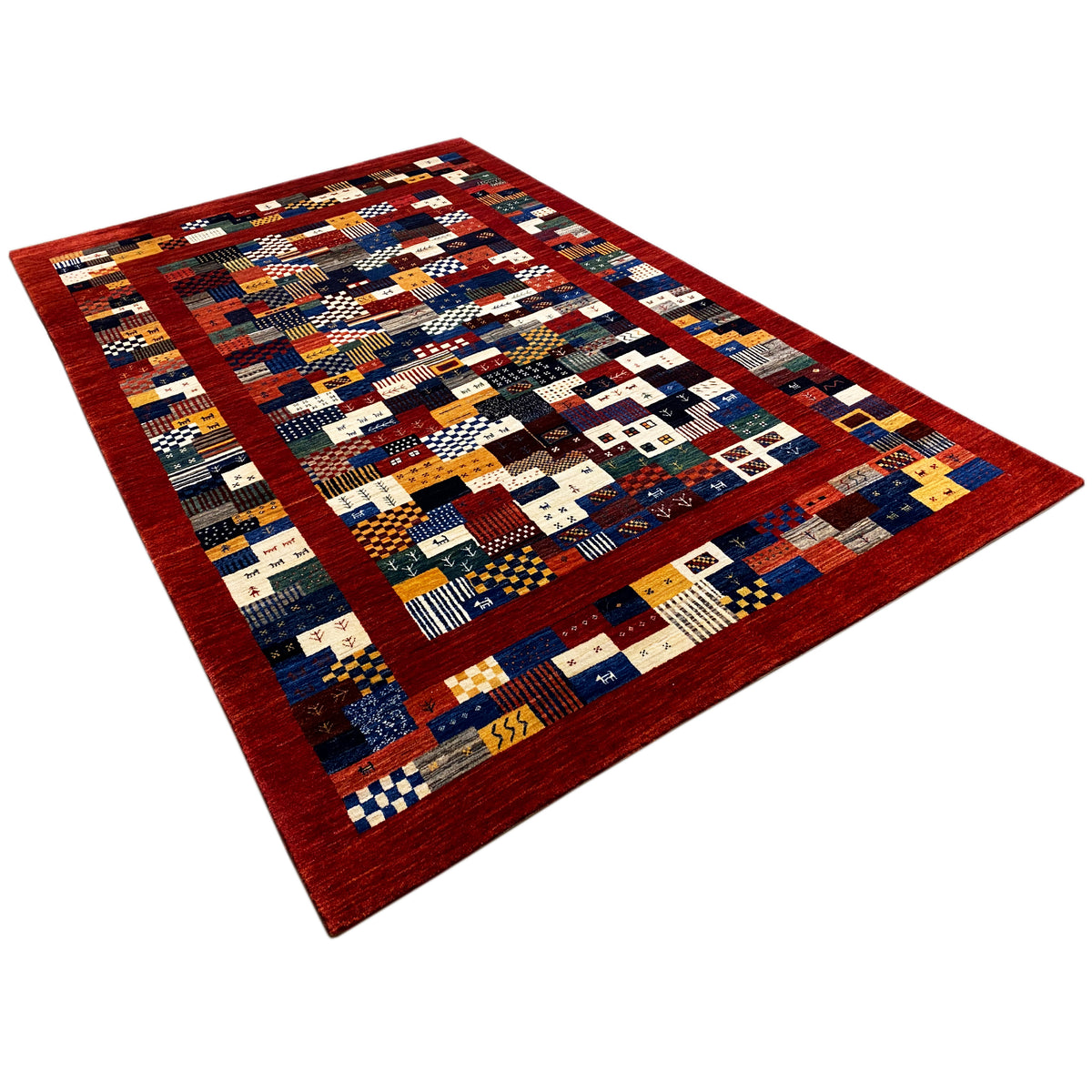 Gabbeh-Luri rug 300x194 cm in angled view, geometric patchwork in red, blue, and cream