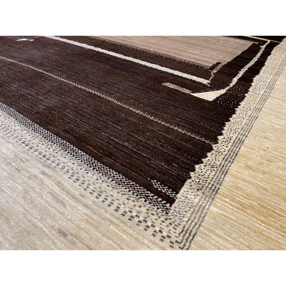 Close-up: Carpet weave with a dark brown center and light decorative border