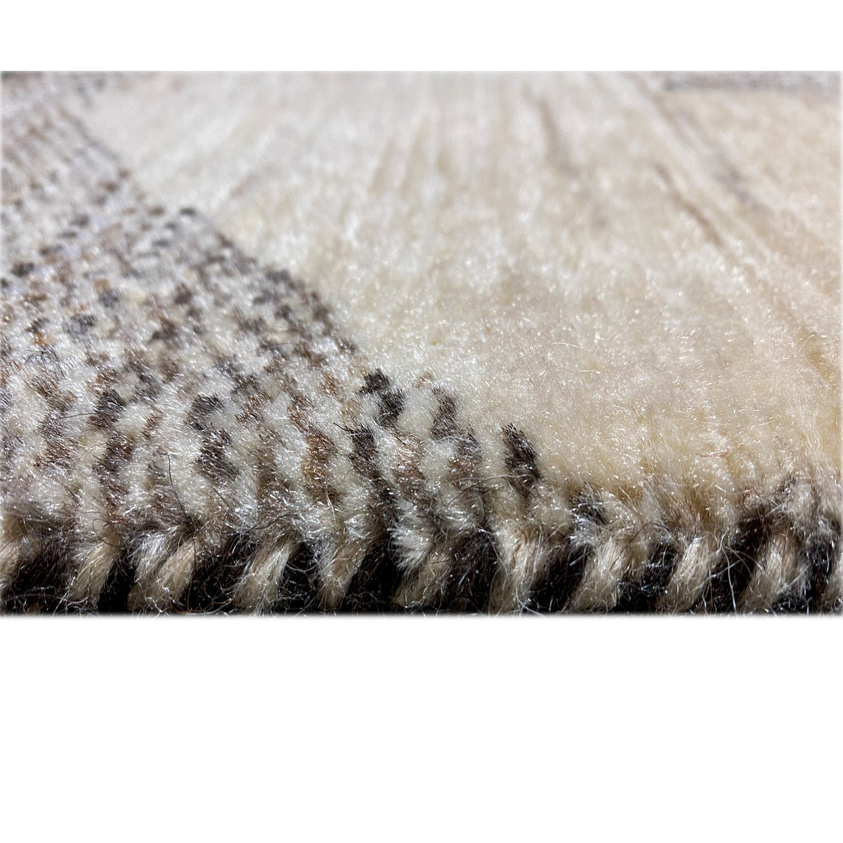 Close-up of the carpet surface with short pile in beige and dark brown areas