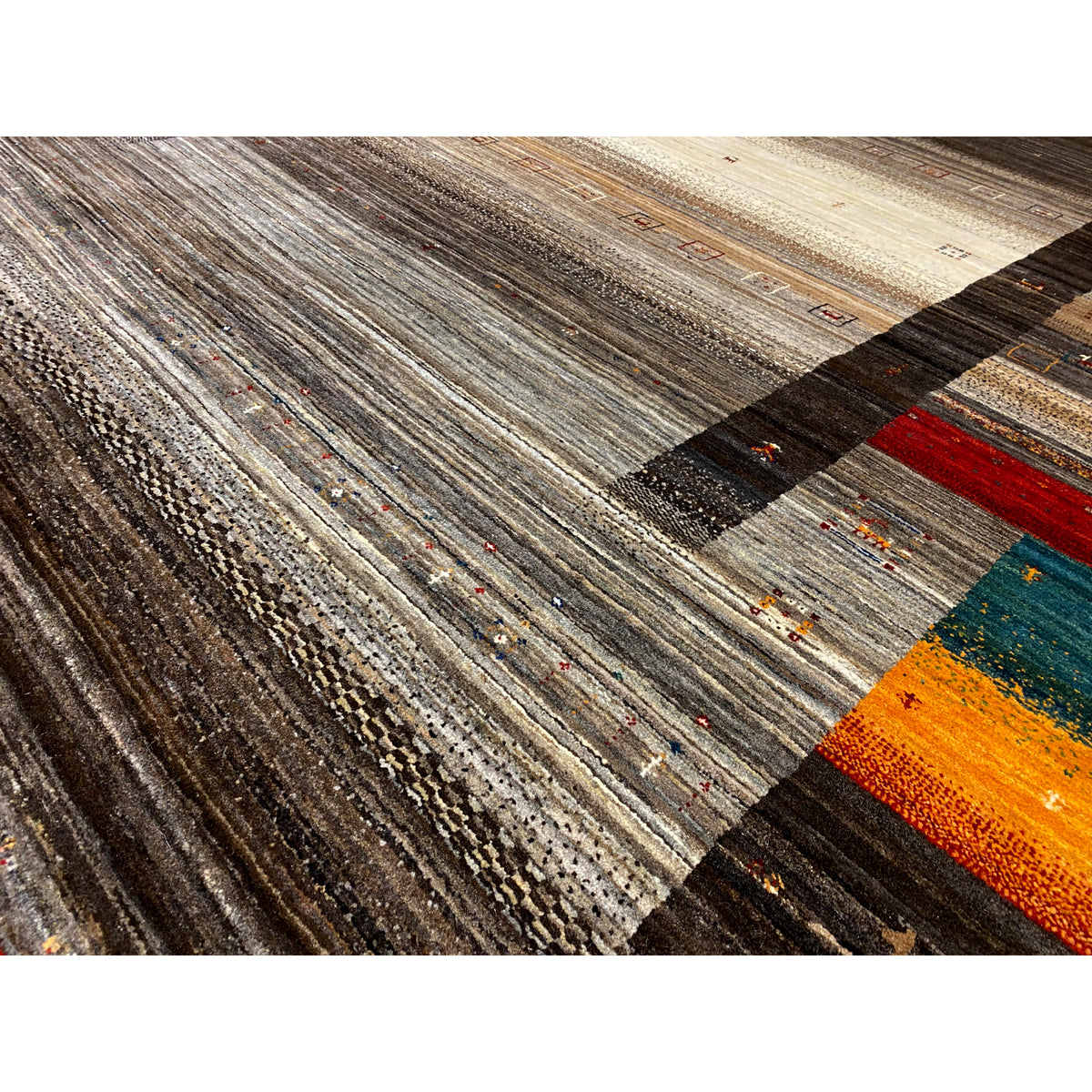 Close-up: textured Gabbeh Luri rug in brown and beige with colorful accents