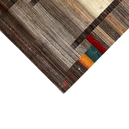 Corner of a Gabbeh-Luri rug with a brown border, beige central field, and colorful quadrilaterals