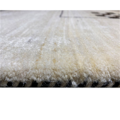 Rug edge with dense, light beige pile and a visible side edge