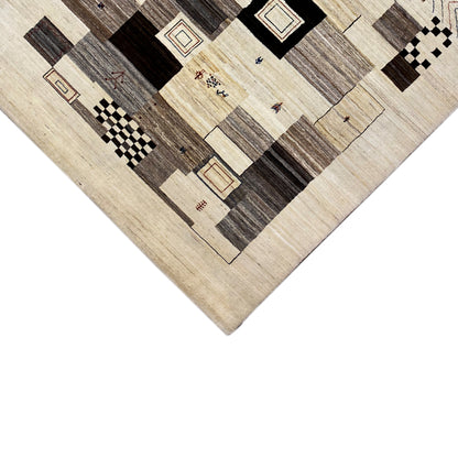 Carpet detail: beige background with dark rectangles, squares, and lines in a patchwork pattern