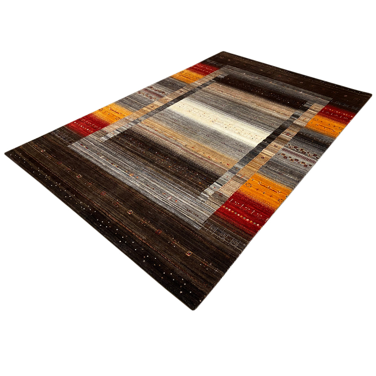 Rug viewed from above at an angle: dark border, central motif in cream and gray, with orange and red