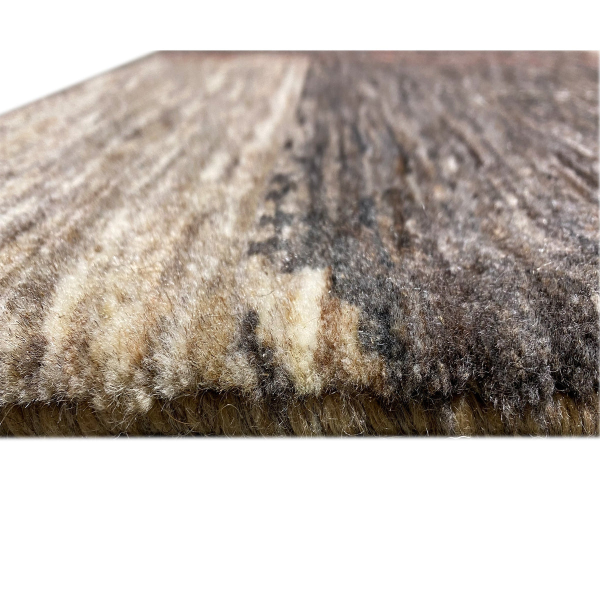 Detail of the carpet surface: marled yarns in gray, beige, and dark sections