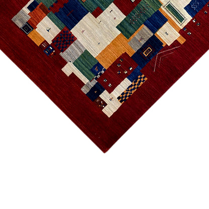 Gabbeh Luri carpet corner close-up: Red with geometric blocks in blue and beige