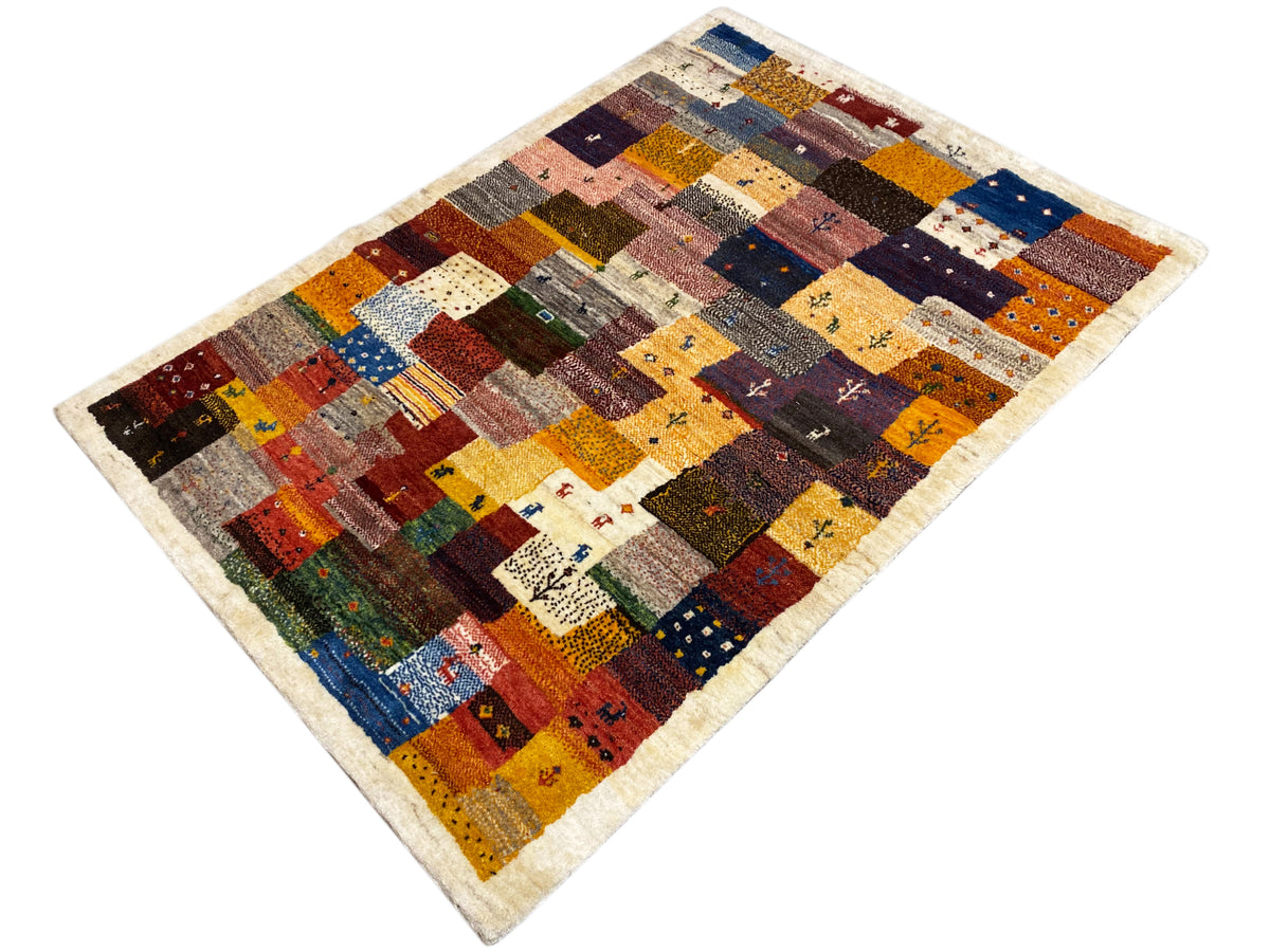Gabbeh Luri rug 145x105 cm diagonal: patterned patchwork fields in red, blue, and yellow
