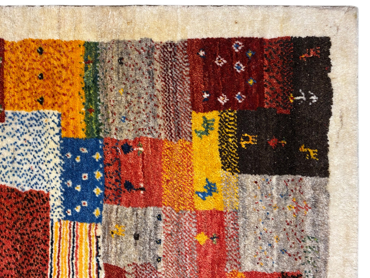 Gabbeh Luri rug 145x105 cm close-up: orange, yellow and blue patchwork fields