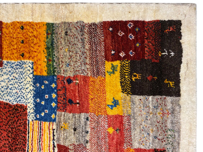 Gabbeh Luri rug 145x105 cm close-up: orange, yellow and blue patchwork fields