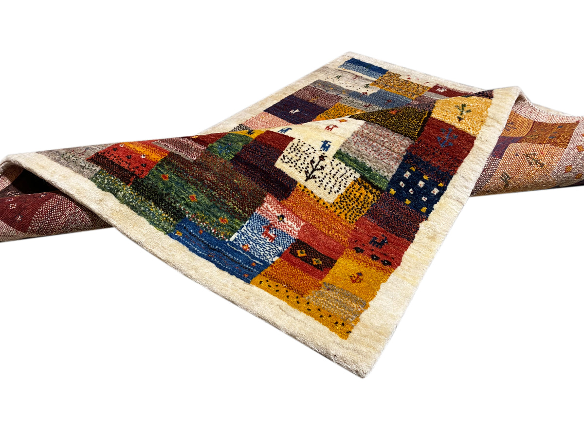 Gabbeh Luri rug 145x105 cm draped diagonally with patchwork blocks in red, blue, and yellow