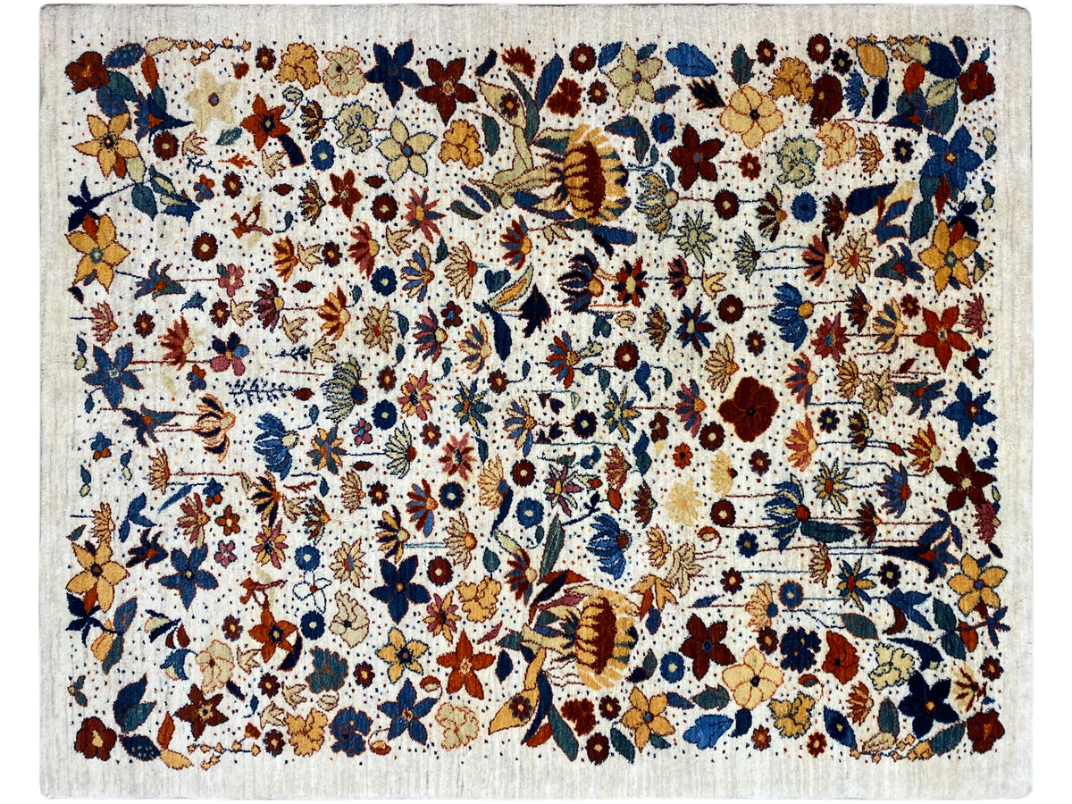 Rectangular rug with a dense multicolored floral and ornamental pattern, light-colored pile