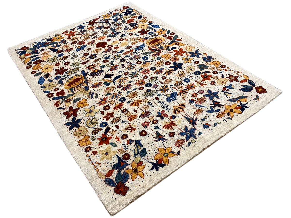 Corner view of a rectangular rug with a multicolored floral pattern on a light background