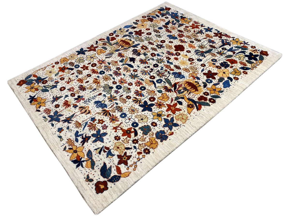 Corner view of the rug: multicolored floral pattern, light base, clearly outlined ornaments